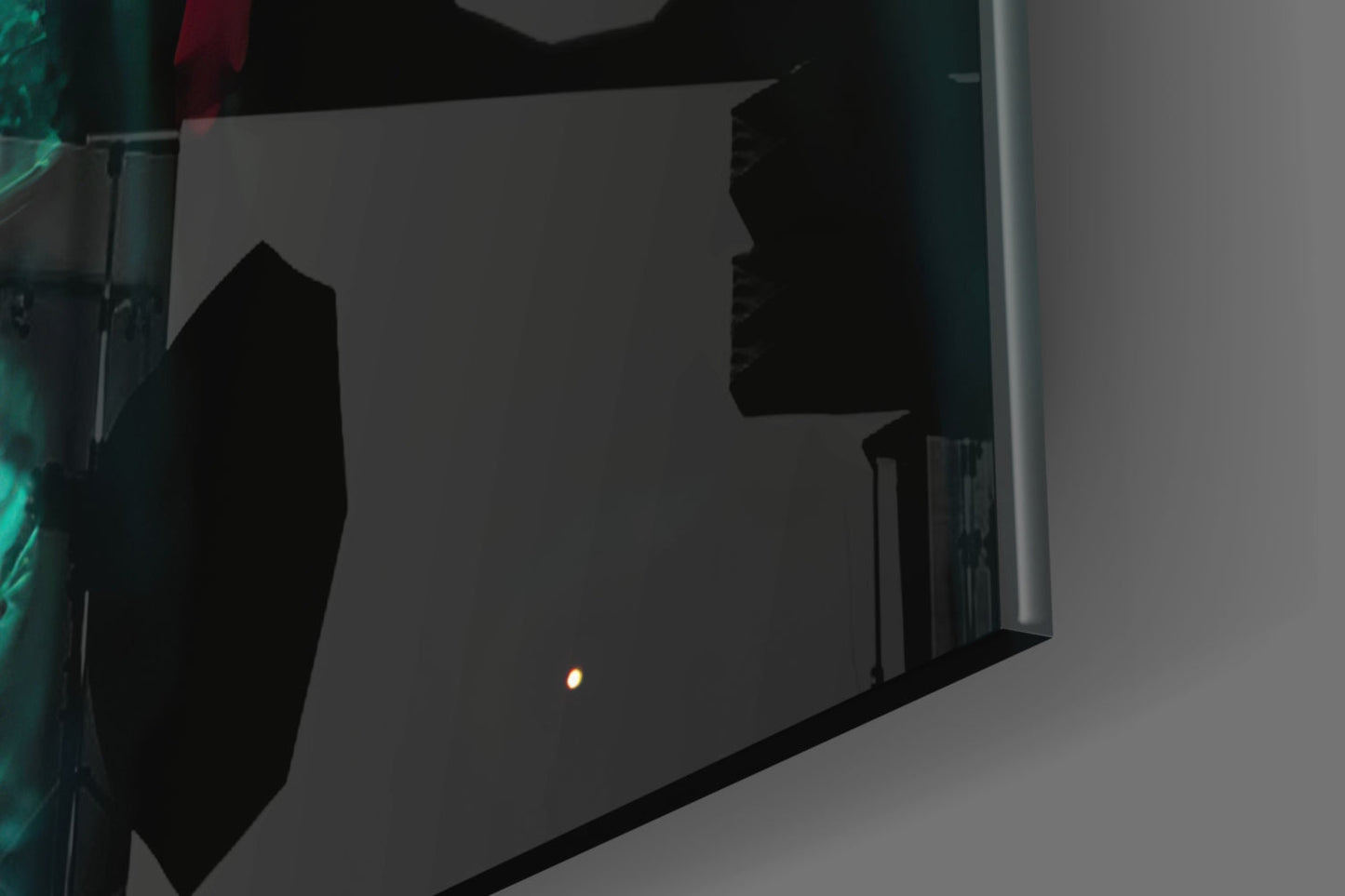 Dark silhouette of Prince Glass Wall Art mounted on gray wall, photographed at angle with single light reflection visible.