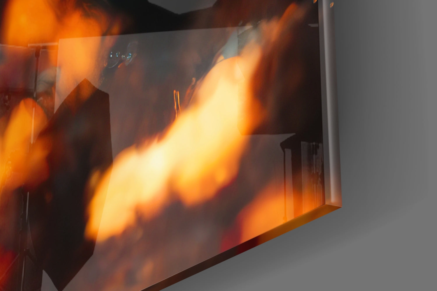 Close-up view of Drift Glass Wall Art displaying vibrant orange and yellow flame patterns printed on translucent glass panel.