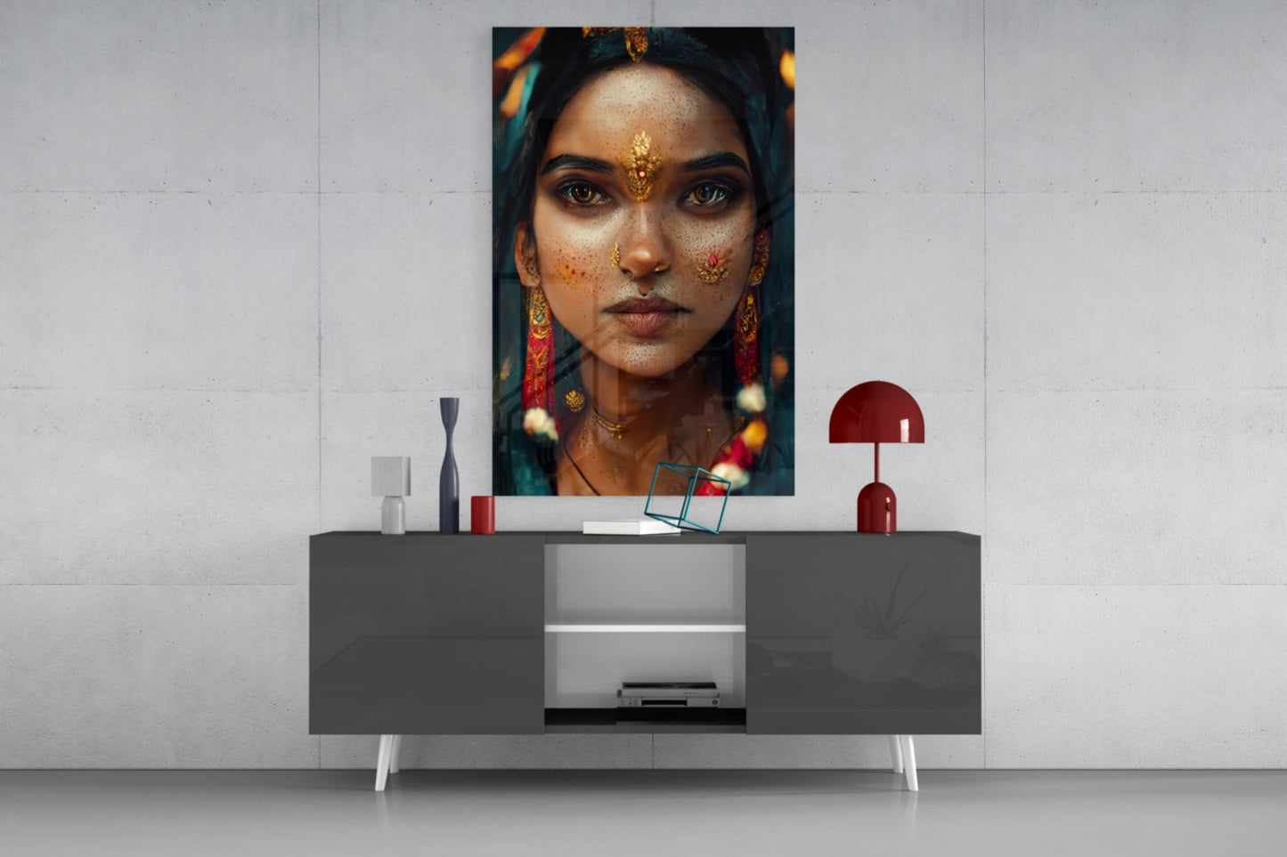 Modern living room display featuring portrait art print of woman with gold jewelry and facial adornments above gray sideboard with decorative objects.