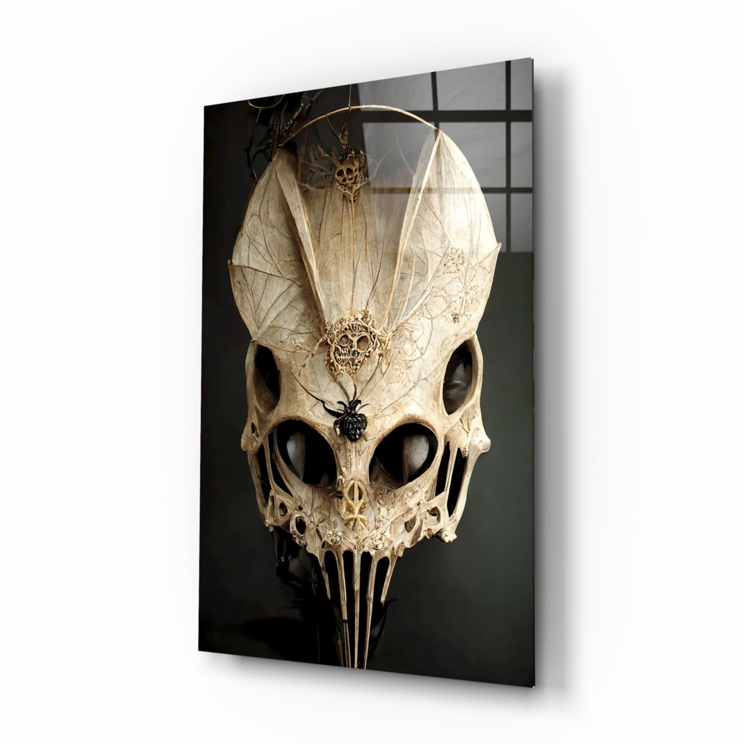Cream-colored ornate skull with delicate wing-like structures mounted on dark background glass panel, angled three-quarter view.