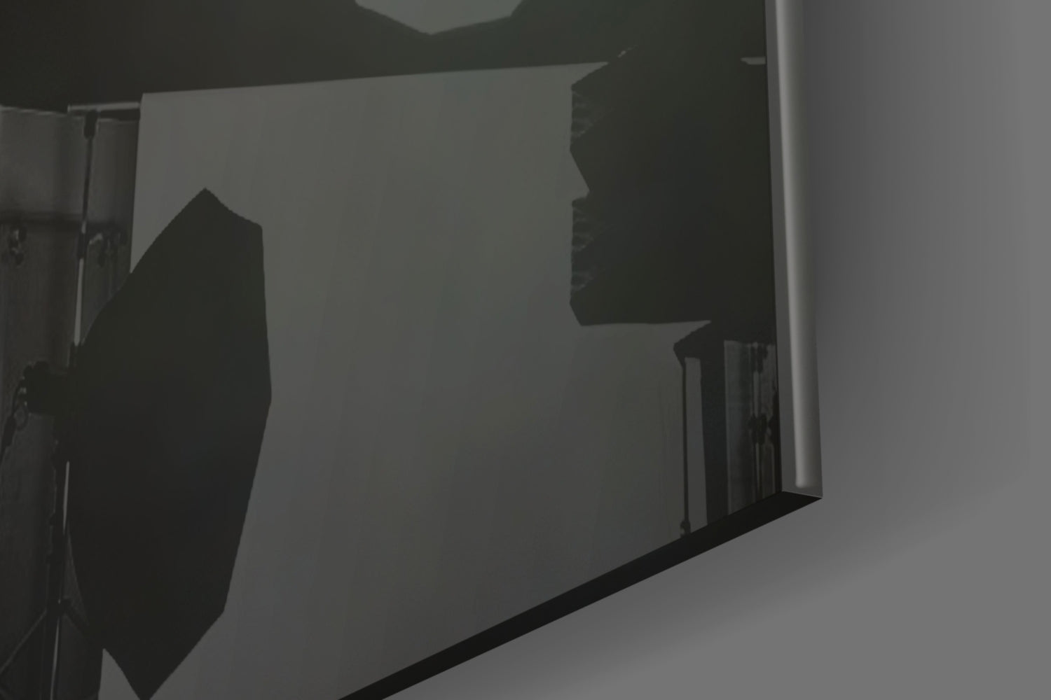 Silhouette of skull glass art displayed against backlit white surface, showing profile view of dark sculptural form.