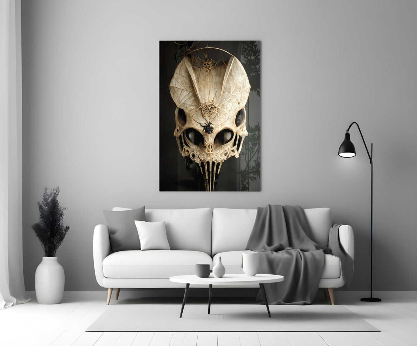 Ornate ivory skull glass art with intricate filigree detailing displayed on white living room wall above sofa.