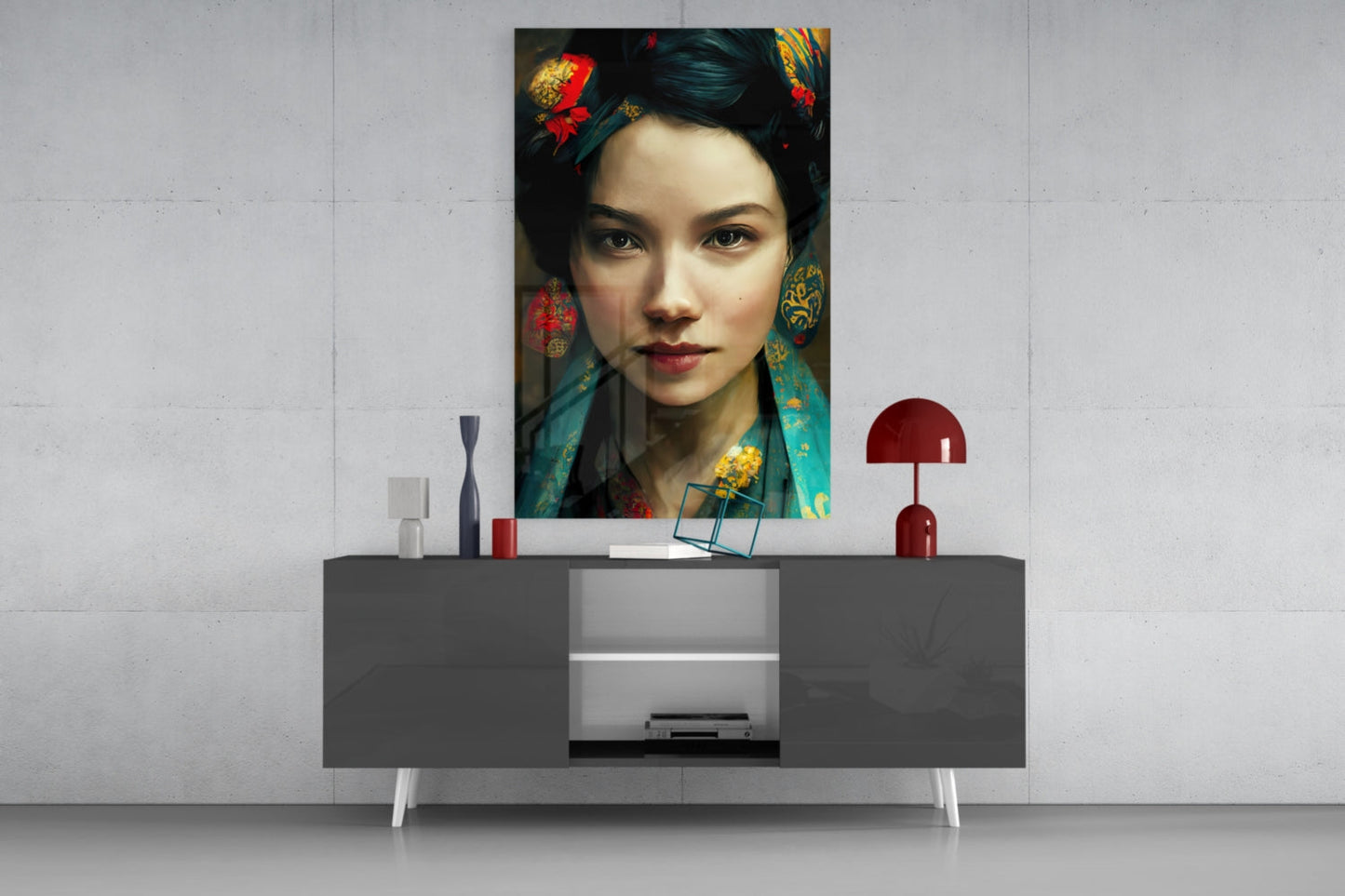 Glass wall art depicting an Asian woman with dark hair, red lips, and ornate gold and teal accessories displayed above a gray console table.