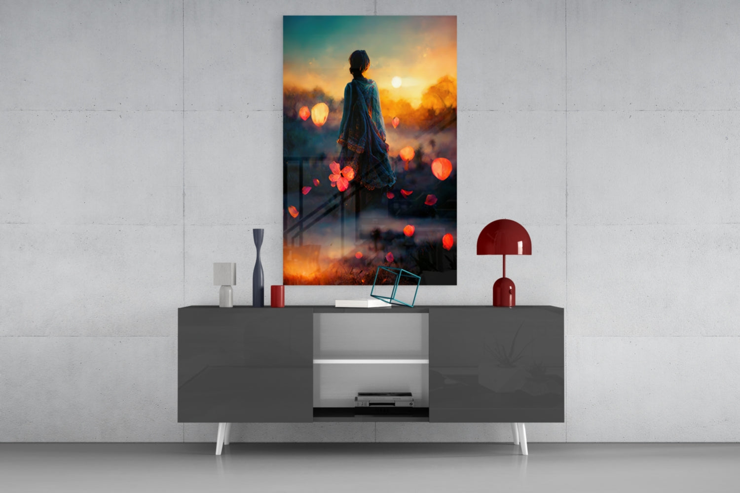 Glass wall art displaying silhouetted figure against golden sunset with floating red bokeh lights, displayed above modern gray console table.