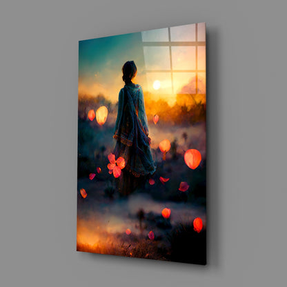 Glass wall art displaying a silhouetted figure facing a golden sunset with floating red lanterns and window grid overlay.