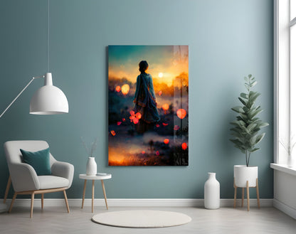 Glass wall art depicting a figure in silhouette facing a golden sunset with floating orange lights and misty landscape.