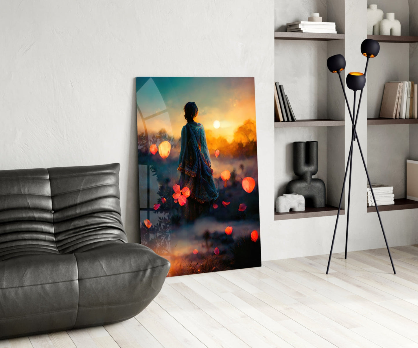 Glass wall art depicting a figure in flowing garments gazing at a golden sunset surrounded by glowing orange lanterns and flowers.