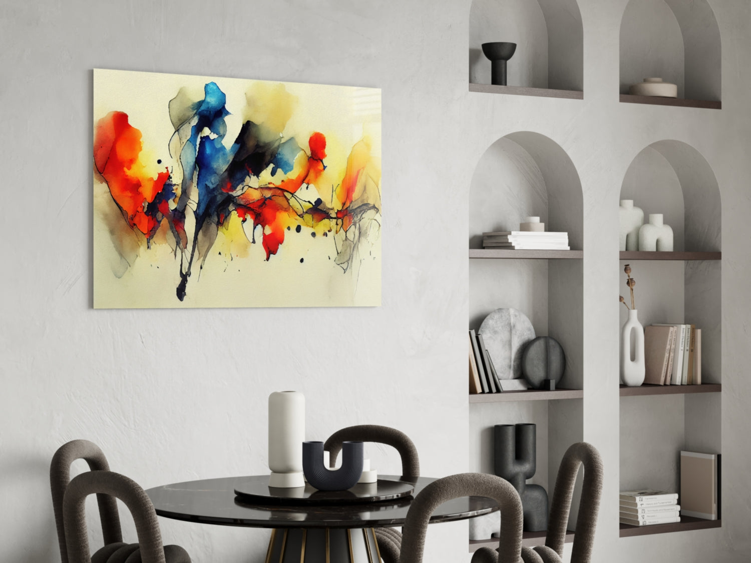 Colorful abstract watercolor art featuring red, blue, and yellow splashes on cream background, displayed above black dining table in modern interior.