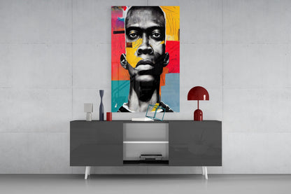Colorful pop art portrait with geometric red, yellow, and teal background mounted on white wall above dark console table with decorative accessories.