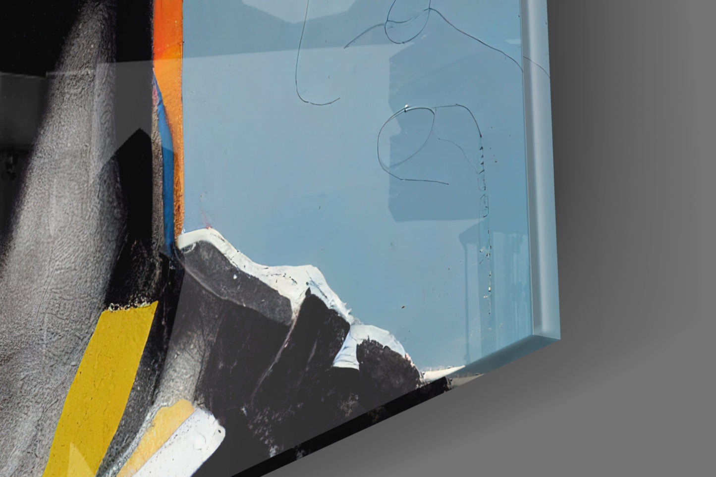 Close-up angled view of light blue glass wall art with sketched line drawings, showing edge detail with yellow and black painted frame border.