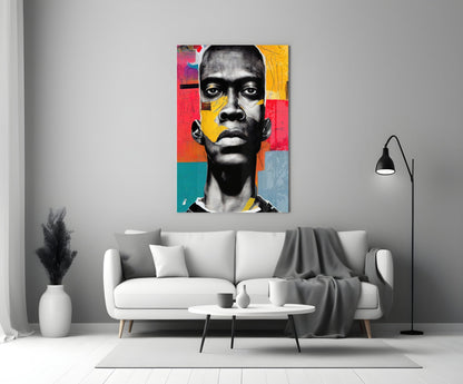 Colorful pop art portrait with black and white face featuring red, yellow, and teal geometric sections, displayed above a white sofa in a modern living room.