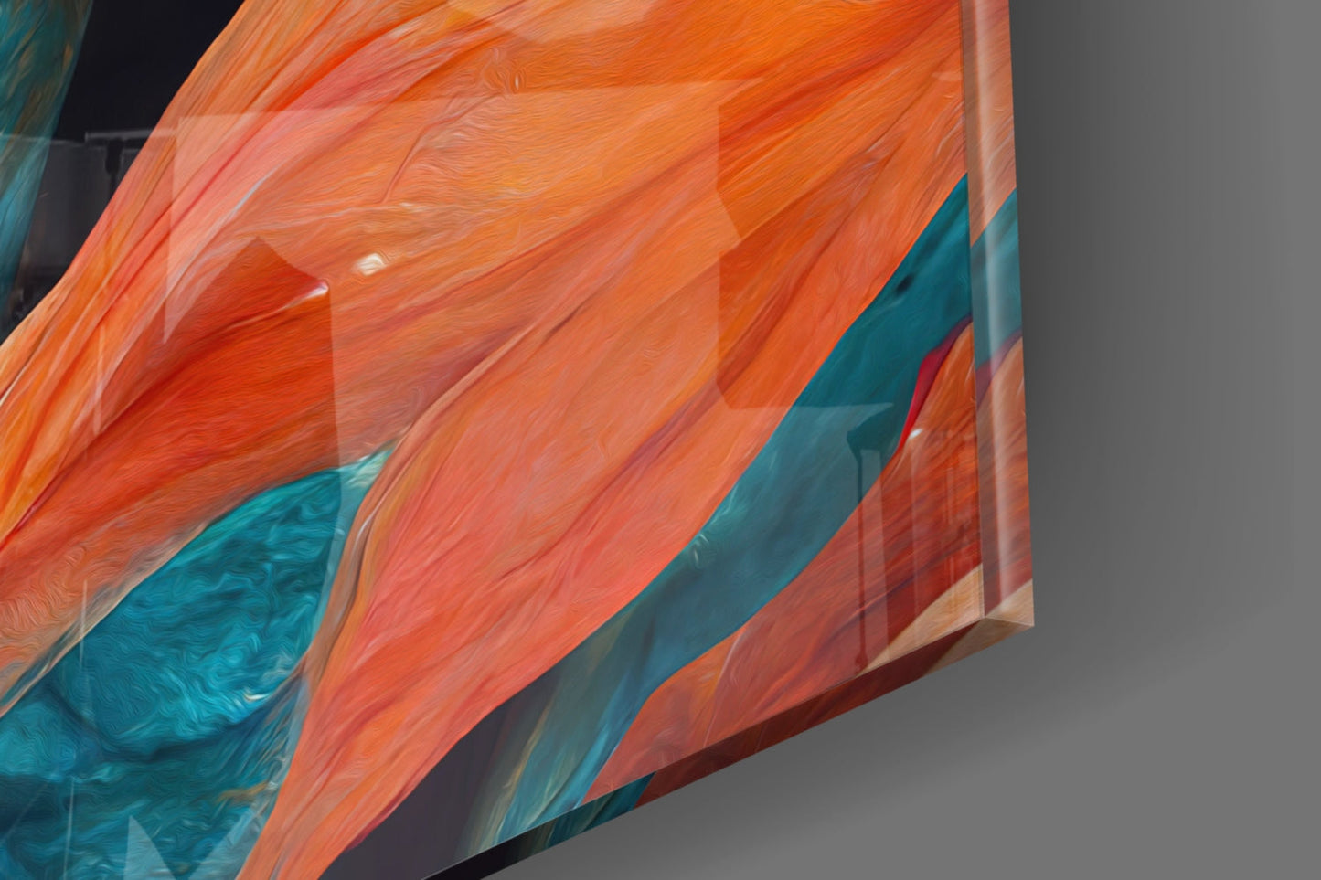 Close-up angled view of translucent glass wall art with orange, coral, and teal brushstroke patterns against gray background.