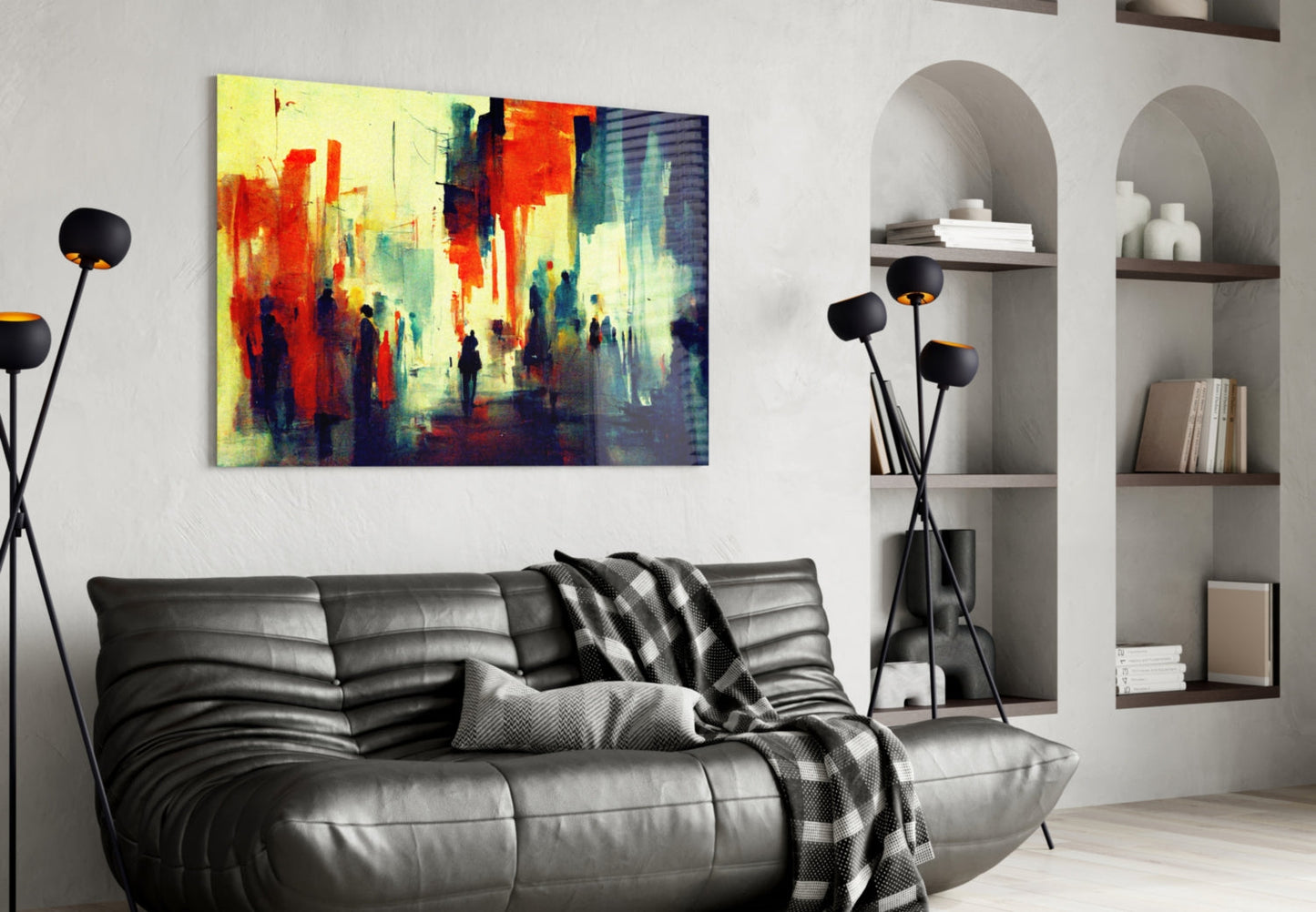 Vibrant abstract cityscape glass art in red, yellow, and blue tones displayed above a black leather sofa in a modern living room.