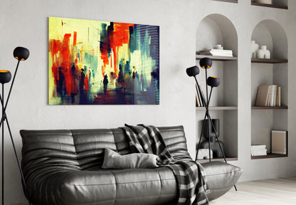 Vibrant abstract cityscape glass art in red, yellow, and blue tones displayed above a black leather sofa in a modern living room.