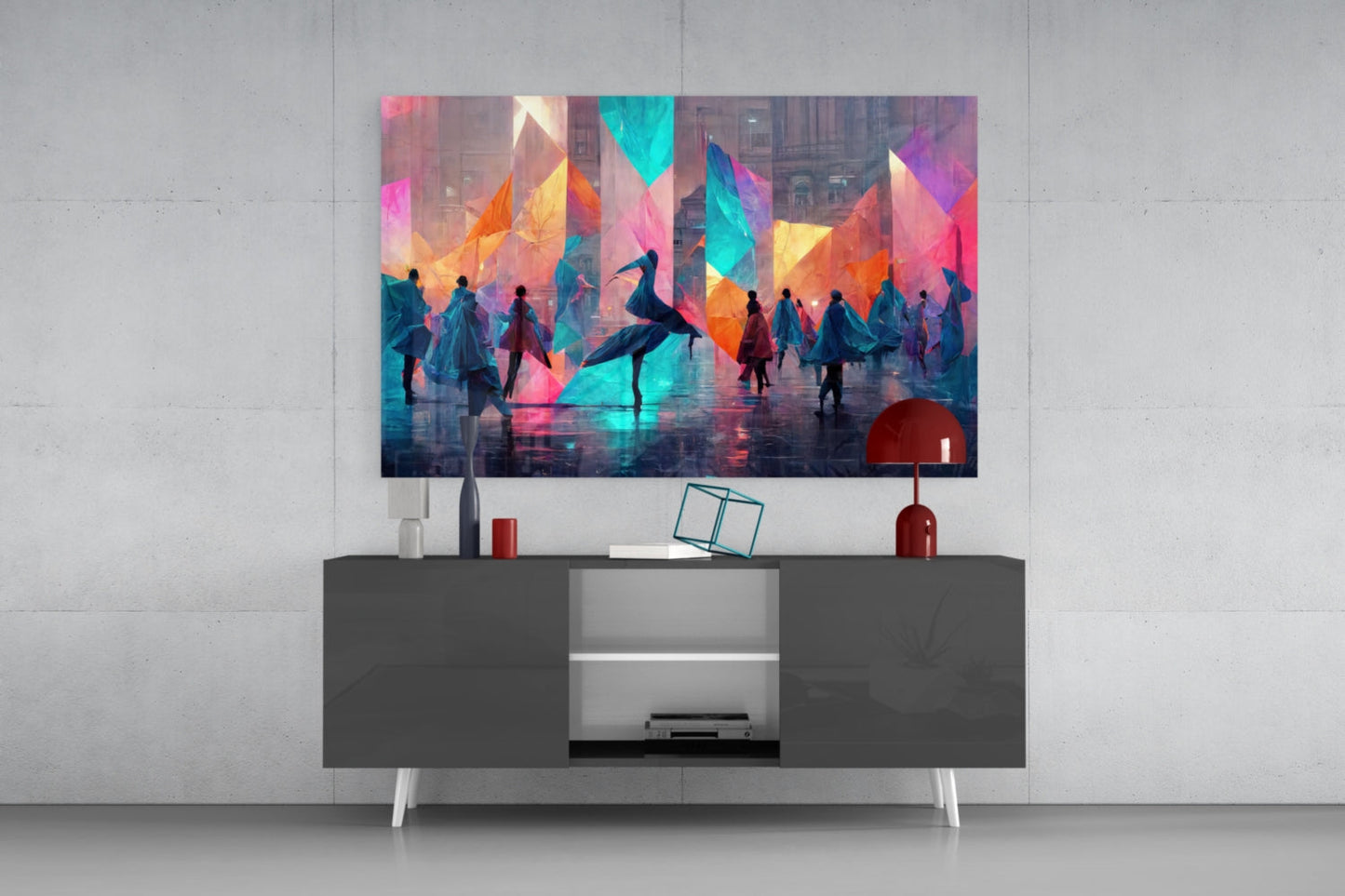 Colorful abstract glass wall art displaying silhouetted figures and geometric shapes in vibrant pink, blue, orange, and yellow tones, mounted above a dark console table.