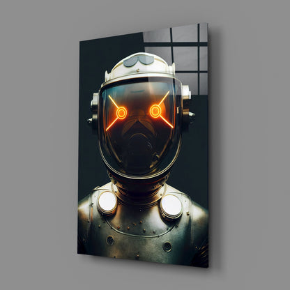 Framed glass wall art displaying a robotic head with glowing orange eyes against a dark background, mounted on a gray wall.