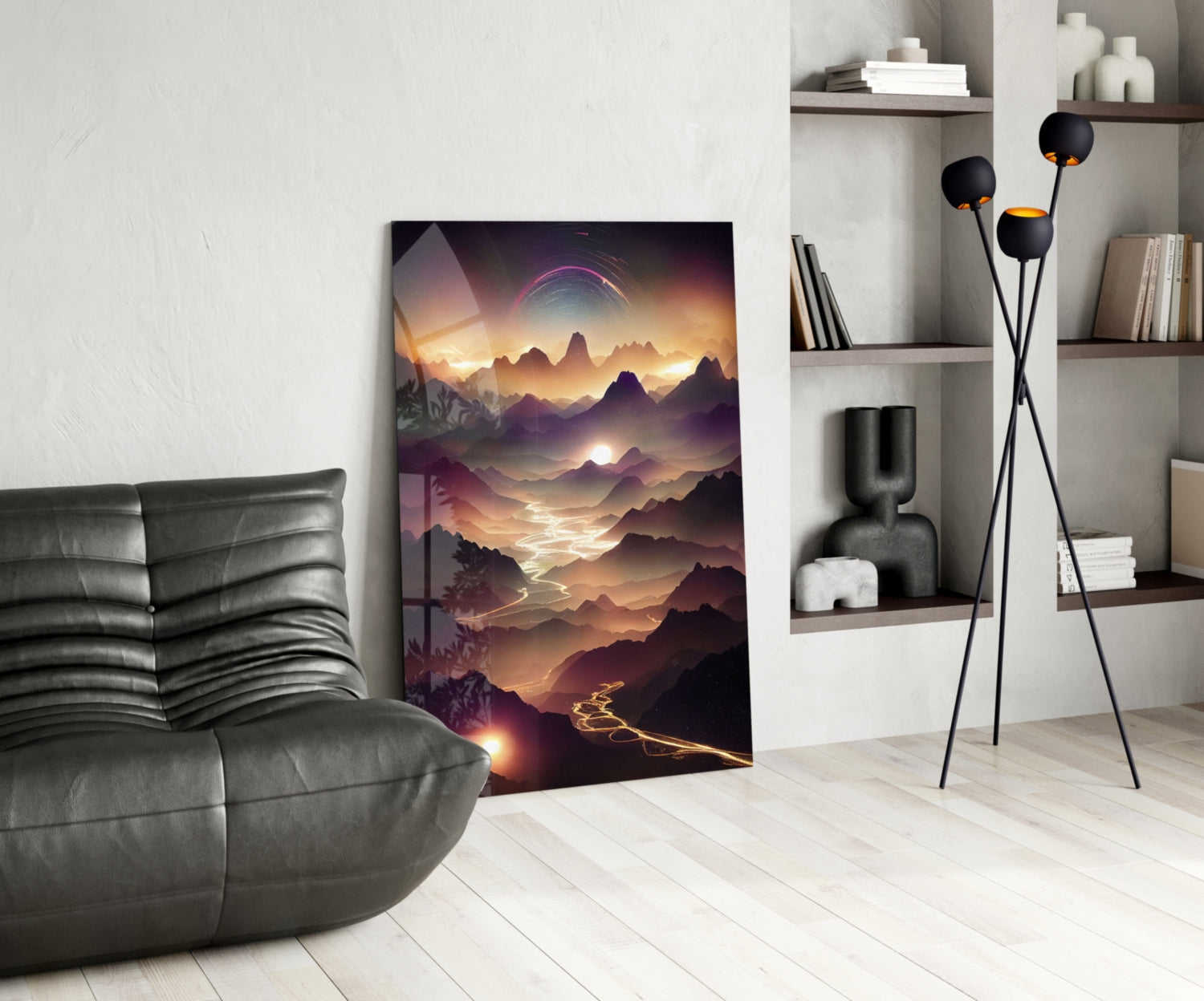 Modern living room interior featuring a large glass wall art panel depicting a golden-hour mountain landscape with glowing lights, positioned beside a dark leather chair.