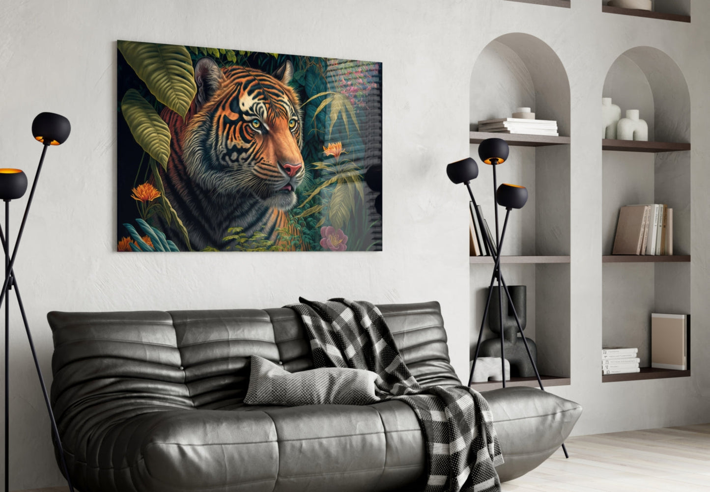 Tiger surrounded by tropical foliage and flowers displayed as glass wall art above black leather sofa in modern living room.