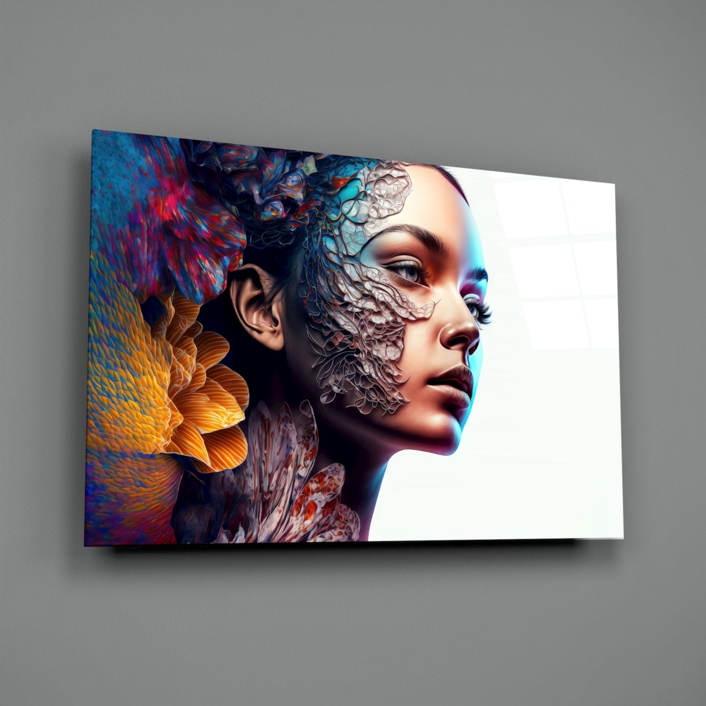 Angled view of glass wall art displaying a woman's profile with colorful abstract textures and digital patterns merged across her face against white background.