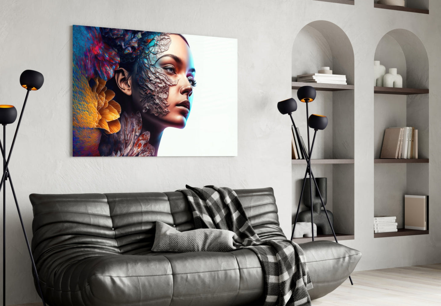 Colorful glass art depicting a woman's profile with abstract blue, red, and gold textures displayed above a black leather sofa in a modern living room.