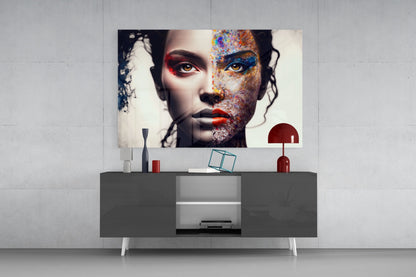 Modern living room setup featuring a colorful abstract portrait glass wall art displaying a woman's face with vibrant paint splatters in red, blue, and gold tones mounted above a dark gray console table.