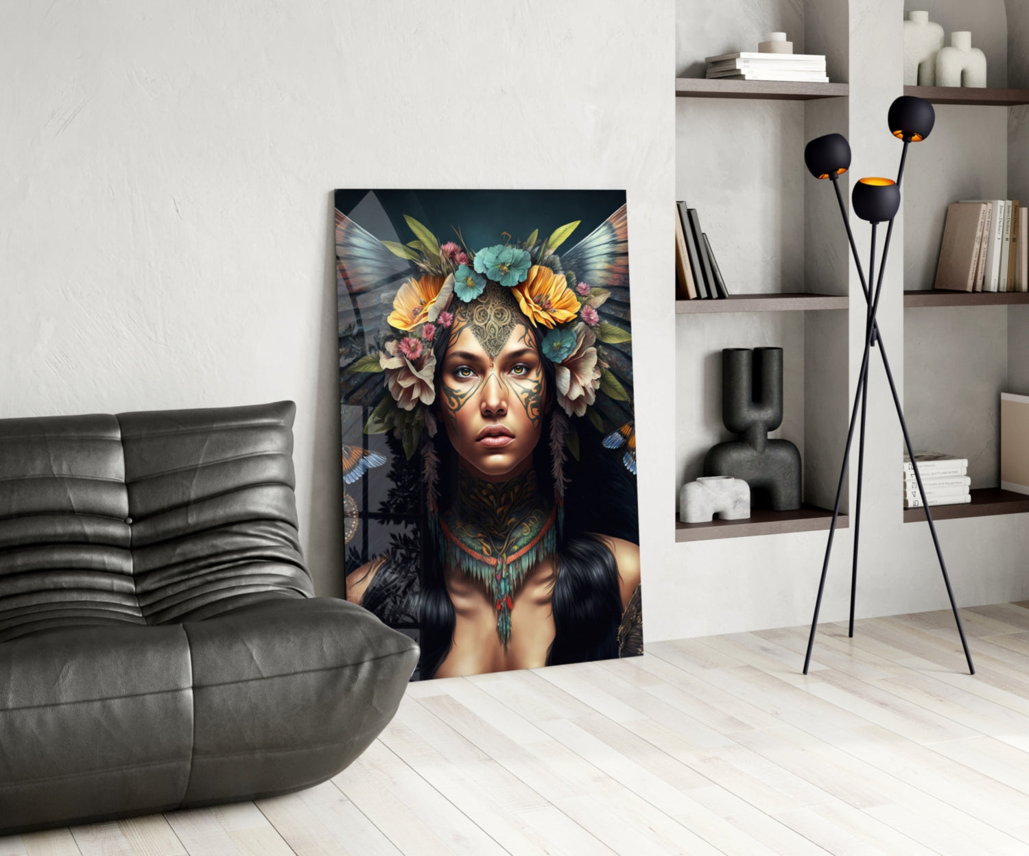 Modern living room with gray leather chair, glass wall art depicting woman with floral headdress and facial tattoos displayed centrally.