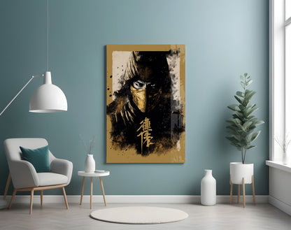 Gold-framed glass wall art depicting a masked warrior figure in black and gold tones displayed in a minimalist room setting.