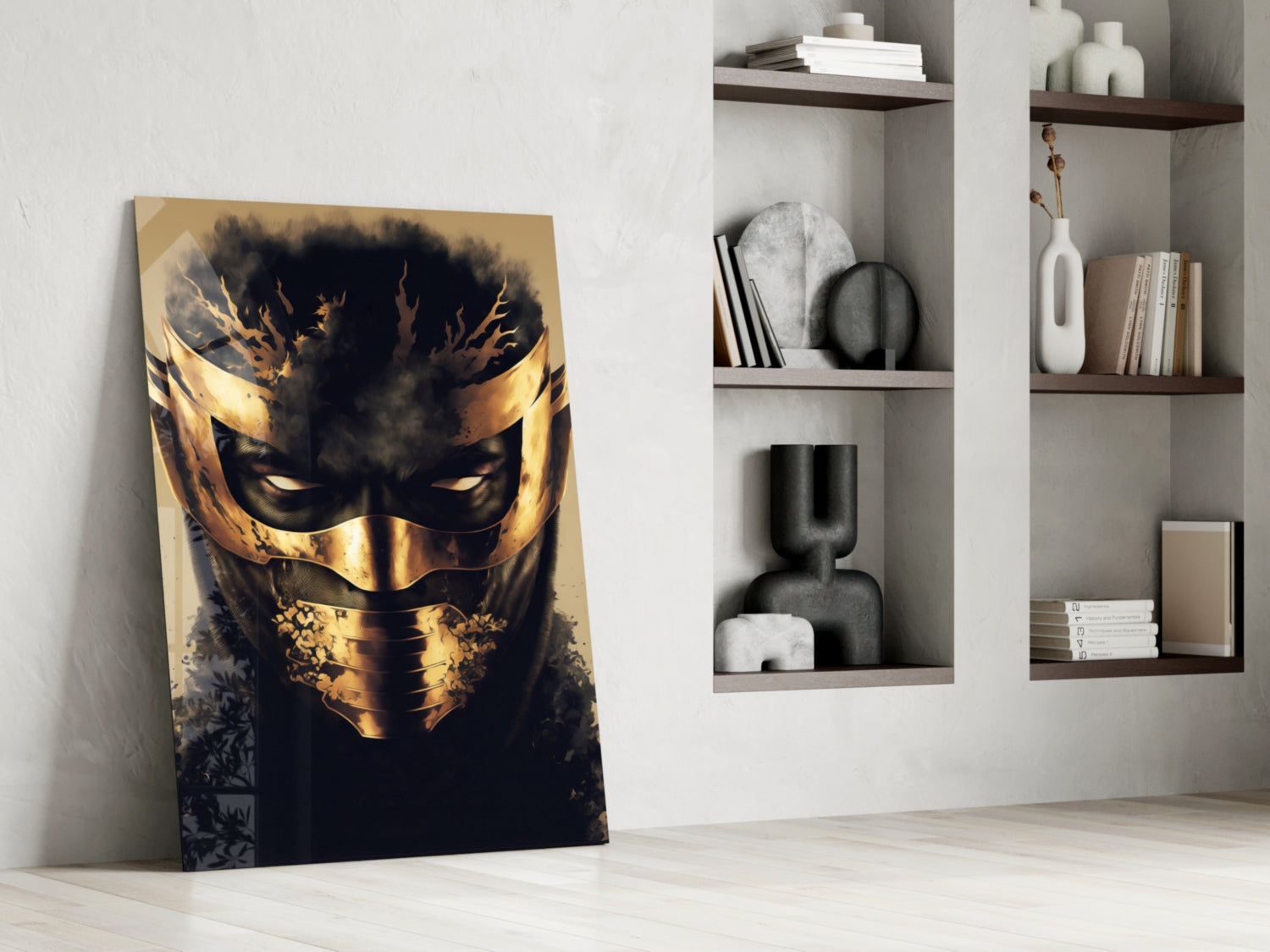 Leaning against white wall, gold and black masked face glass art panel beside white shelving unit with decorative objects and books.