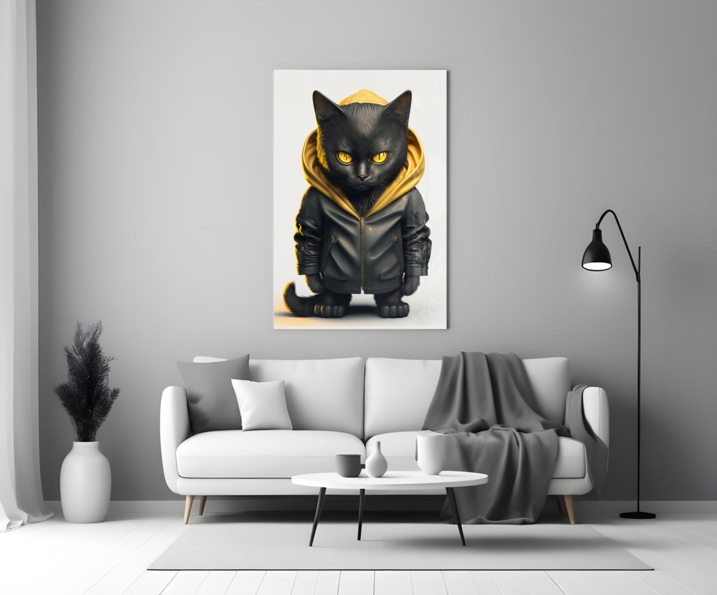 Black cat wearing gold-trimmed hoodie displayed on white wall above gray sofa in modern living room.