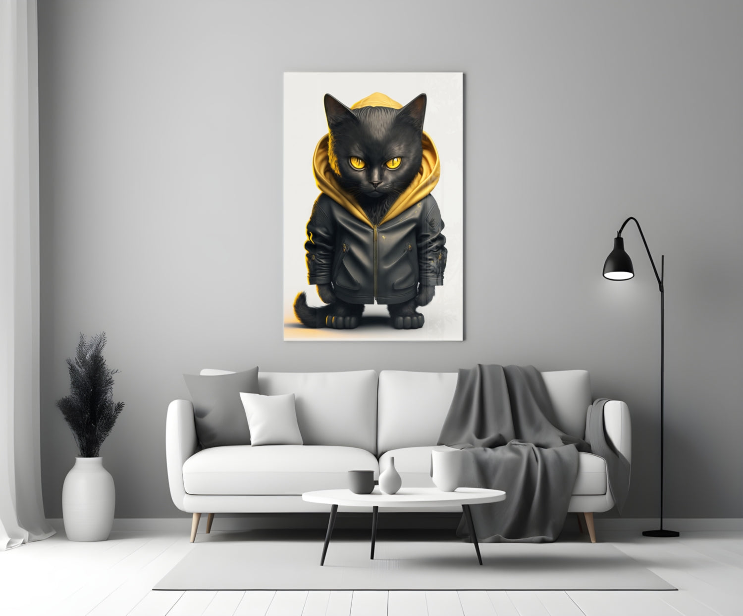 Black cat wearing gold-trimmed hoodie displayed on white wall above gray sofa in modern living room.