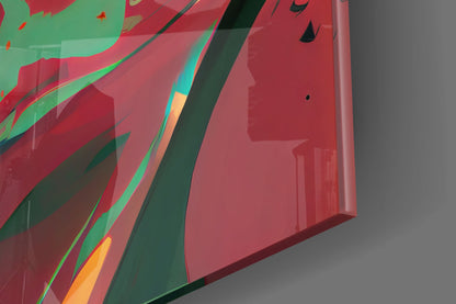 Close-up angled view of red glass wall art with green, orange, and dark geometric stripes and abstract shapes against gray background.