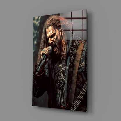 Angled perspective of glass wall art featuring a long-haired male vocalist with beard singing into microphone, wearing dark patterned clothing against dark background.