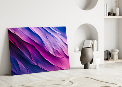 Purple Dance glass wall art leaning against white wall in minimalist room with shelving and decorative objects.