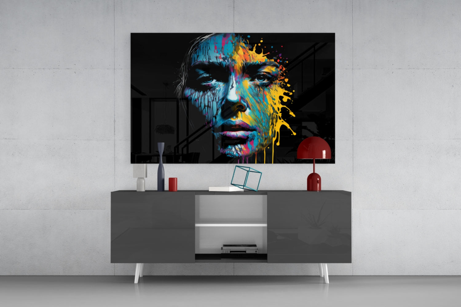 Colorful splash glass wall art featuring a portrait with blue and yellow paint effects displayed above a gray media console in a modern interior setting.