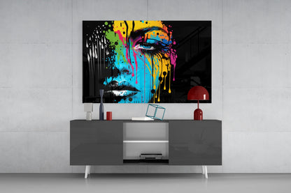 Colorful pop art portrait with melting paint effect mounted above gray media console in modern living room setting.
