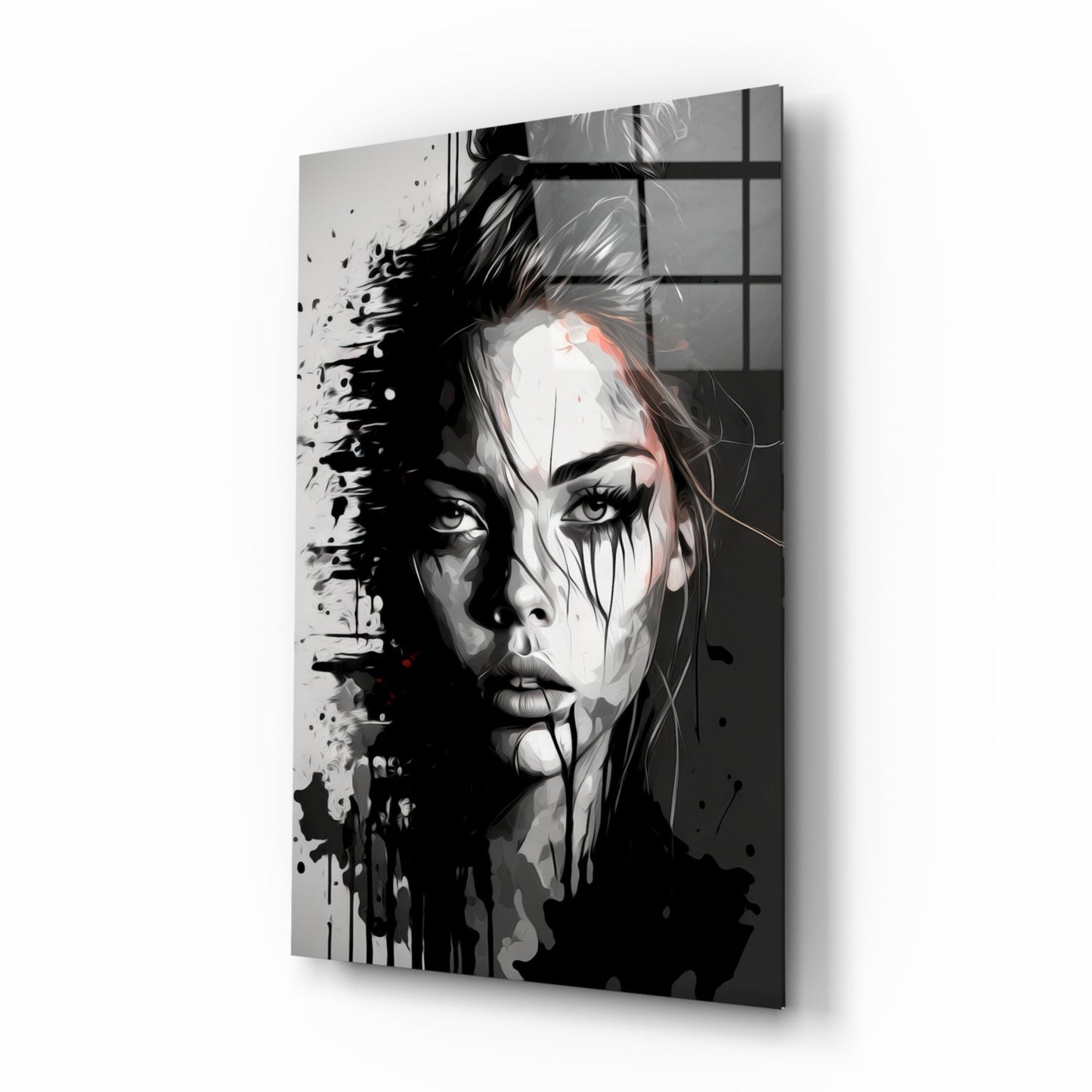 Abstract black and white portrait of a woman's face with splatter effects on glass wall art, displayed at an angle.