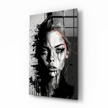 Abstract black and white portrait of a woman's face with splatter effects on glass wall art, displayed at an angle.