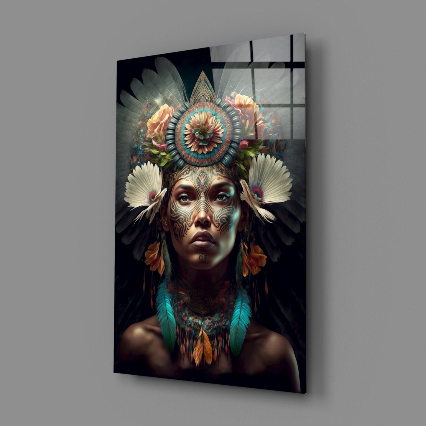 Glass wall art panel displaying a portrait of a tattooed face with ornate floral headdress and feathered wings against dark background.