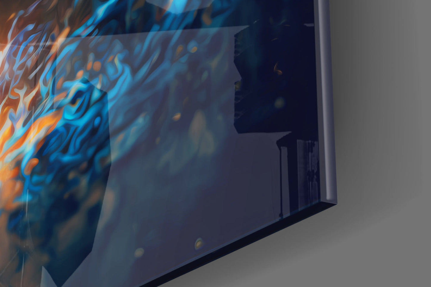 Close-up angled view of glass wall art displaying blue and orange flame patterns with silhouetted interior design.