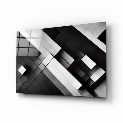 Three-dimensional cubic glass wall art with intersecting black and white geometric planes casting shadows against a light background.
