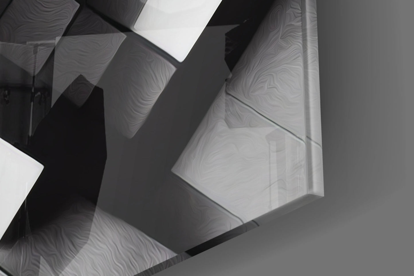 Close-up overhead view of overlapping translucent cubic glass panels with wavy surface textures casting dramatic shadows in monochrome tones.