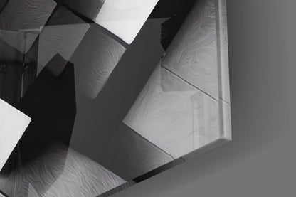 Close-up overhead view of overlapping translucent cubic glass panels with wavy surface textures casting dramatic shadows in monochrome tones.