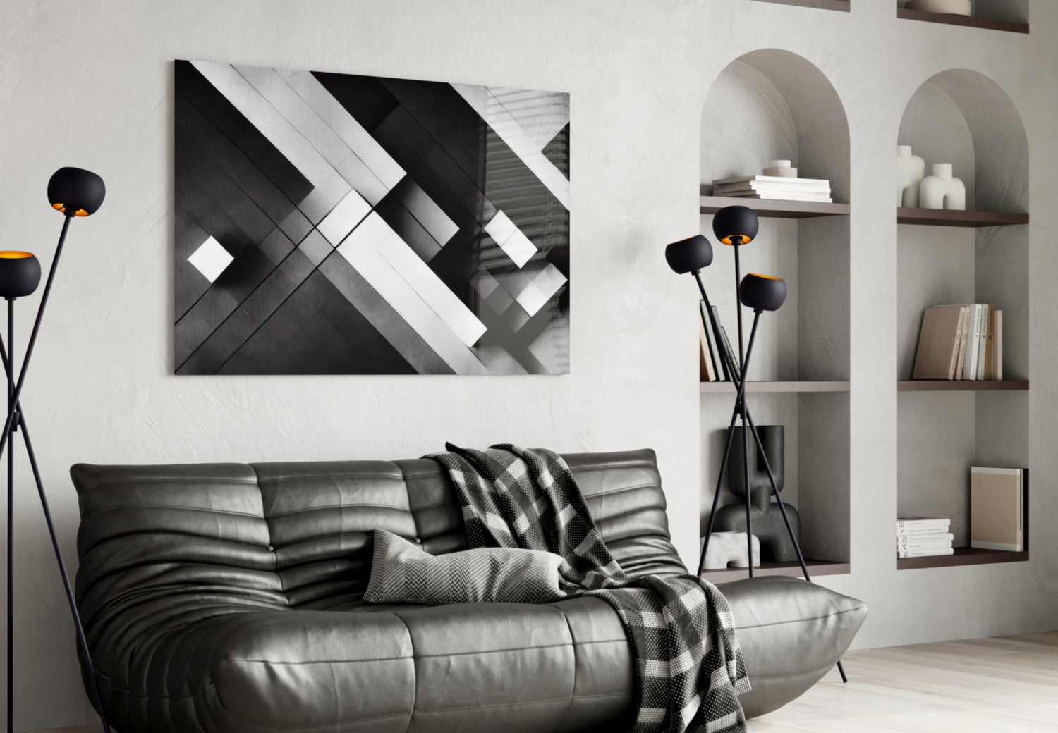 Modern living room with black leather sofa displaying abstract black and white geometric glass wall art above it.