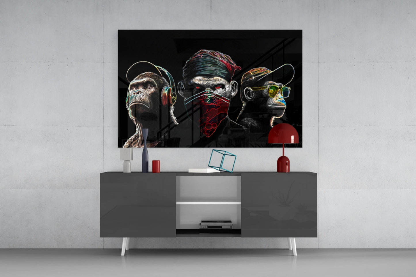 Neon-lined glass art depicting three stylized monkeys with headphones, bandana, and sunglasses mounted above gray media console in modern interior.