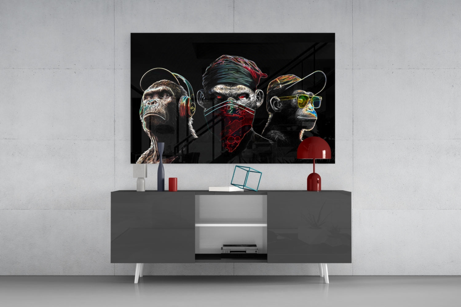 Neon-lined glass art depicting three stylized monkeys with headphones, bandana, and sunglasses mounted above gray media console in modern interior.