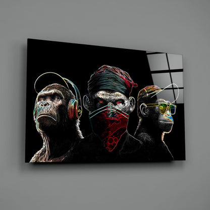 Three neon-outlined chimps wearing headphones, bandana, and glasses against black glass, angled perspective view.