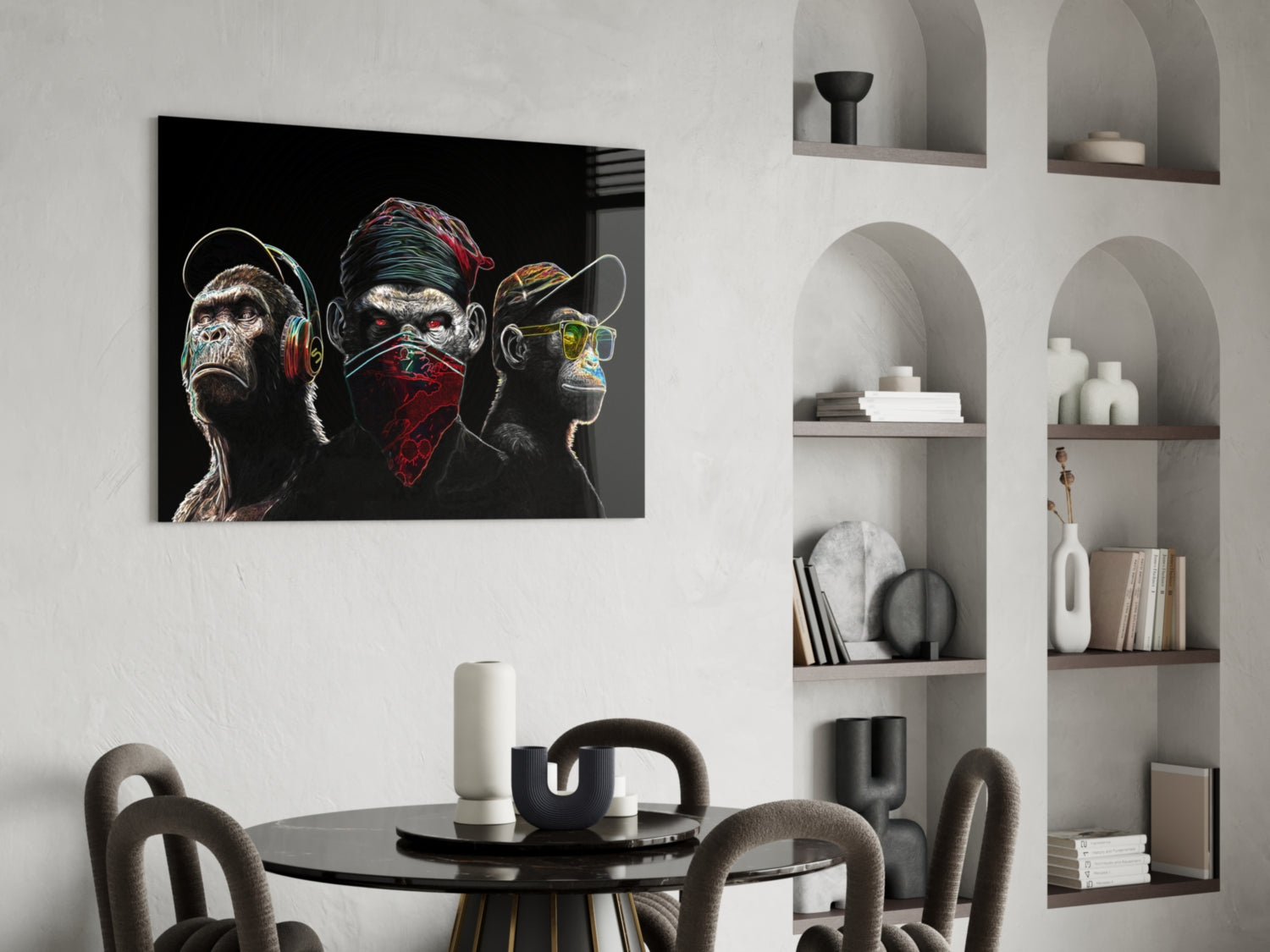 Neon-styled glass artwork of three stylized monkeys with headphones and bandana displayed above a dining table in a modern interior.