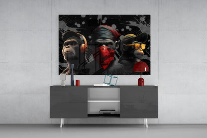 Three stylized monkeys wearing headphones and accessories displayed above a gray media console in a modern living room setting.