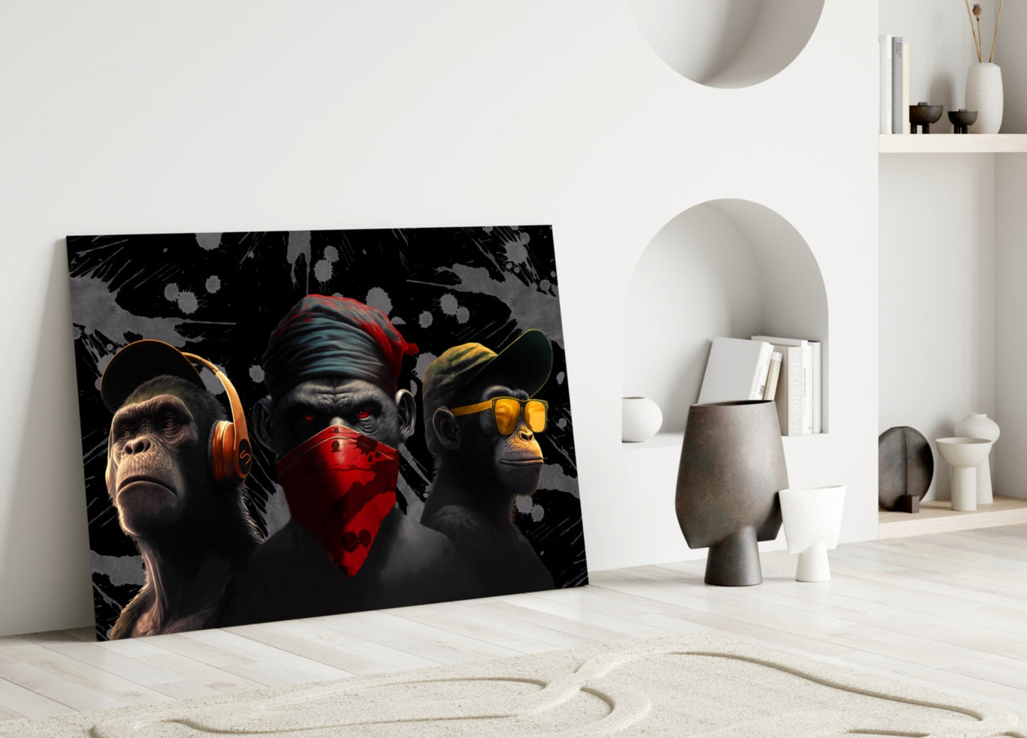Three stylized monkeys with colored accents leaning against white wall in minimalist interior setting.