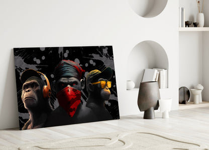 Three stylized monkeys with colored accents leaning against white wall in minimalist interior setting.